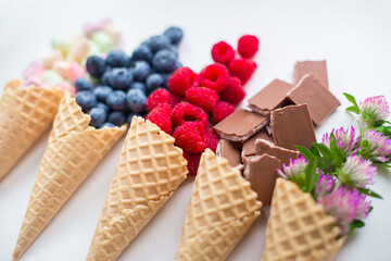 berries, chocolate and flowers in waffle cones