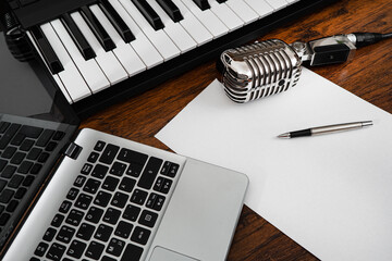 Music studio equipment and white paper with pen. Songwriting concept.