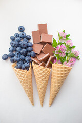 berries, chocolate and flowers in waffle cones