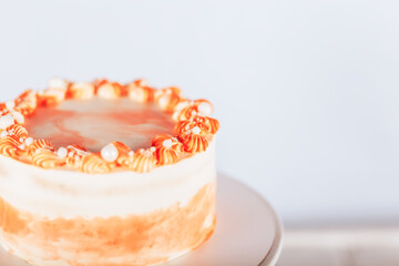 Beautiful carrot cake on a stand. Sweets for any occasion. Birthday and Christmas present. Opposite white background