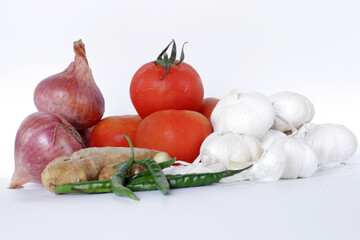 Fresh Vegetable Onion Tomato Ginger Garlic green chilly on white background