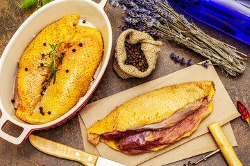 Preparation raw duck breasts with sea salt, fresh rosemary, dry lavender and chili