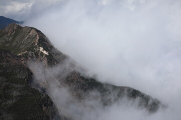 Mountain ridge covered with deep cloud