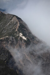 Mountain ridge covered with deep cloud