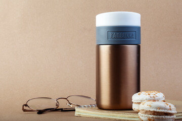 KIEV, UKRAINE - DECEMBER 03, 2020: Reusable thermos cup KAMBUKKA made of 18/10 steel. Convenient waterproof travel mug with valve lid and lock.