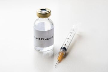a vial with a medicine for the coronavirus, a vaccine for covid-19 with a syringe and needle