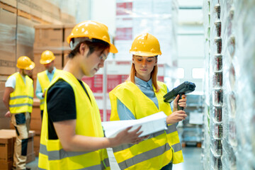 Workers in warehouse scanning packages