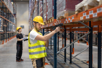 Workers in warehouse scanning packages