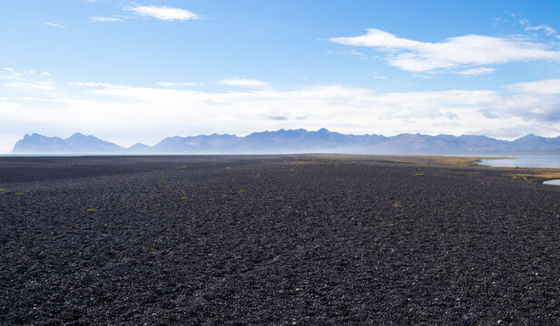 Hvalnes peninsula with a black pebble beach. East Iceland.