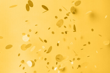 Confetti on fortuna gold background. Copyspace for text. Bright and festive holiday background. - obrazy, fototapety, plakaty