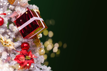 Fir Tree decorated with christmas balls on rustic wood and sparkles light backgorund