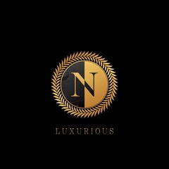 Fototapeta premium Golden N letter Logo Luxurious Nature Leaves, elegance vector design concept circle floral leaves with negative space letter logo.