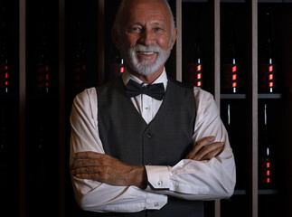 Portrait of satisfied winemaker in his wine cellar