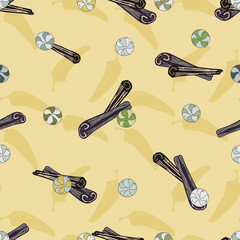 Cinnamon sticks, peppers, candies on a yellow  background. Fragrant spicy spice. Seamless pattern. Vector repeating background