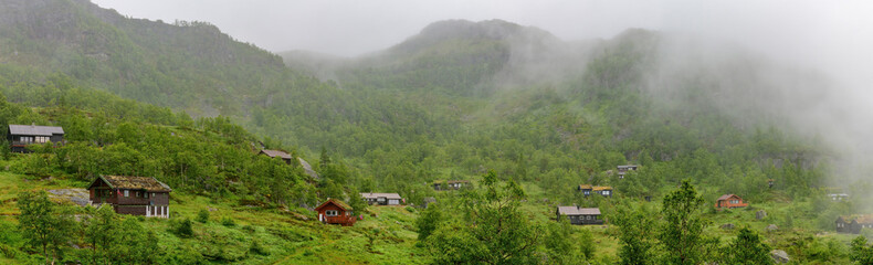 Fototapeta na wymiar Norwegian style holiday cottages in the misty mountains of northern Norway.