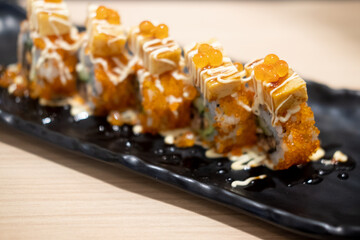 Maki sushi salmon roe on top with tamako