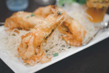 Crispy fried prawn with garlic and pepper in white plate