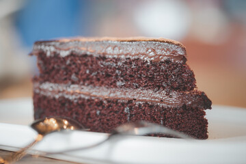 Selective focus of triangle piece of dark chocolate fudge cake