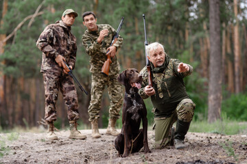 Man Hunter Pointing Somewhere for Hunting Dog.