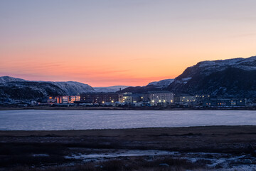 Winter Teriberka. Evening polar landscape with the village of Lodeynoye located between the polar hills