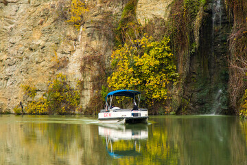 Mtkvari river and boat, autumn time trees and landscape in the city center of Tbilisi