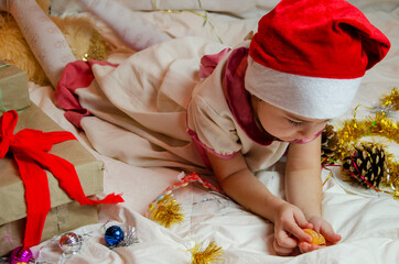 Kid with New Year's gift close-up.2021 calendar.Child on a Christmas background.Child eats tangerines for New Year.Happy New Year.Merry Christmas.Happy new year card with place for inscription.