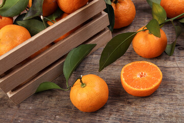 mandarin orange green leaf wood crate box on rustic wooden background