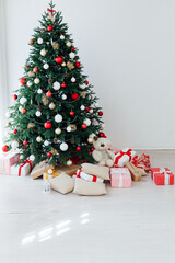 Fototapeta na wymiar beautiful Christmas tree interior with new year decor gifts