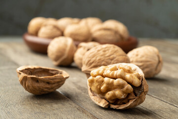 Walnuts over a wooden table and on a plate