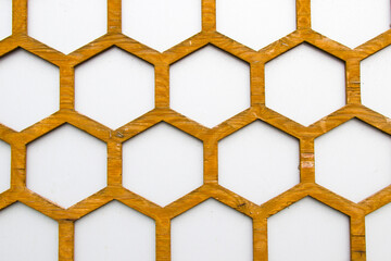 Honeycomb background, wooden comb and white wall