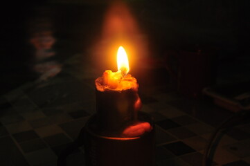 burning candle in the dark