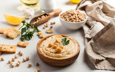 Hummus in a wooden plate with parsley and croutons. Dishes of chickpeas, a vegetarian dish.