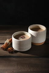 Ceramic cup of masala tea with spice on a wooden table