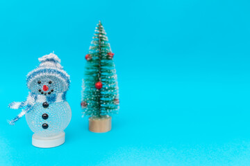 Toy snowman christmas tree on blue background copy space. Merry Christmas and Happy New Year.