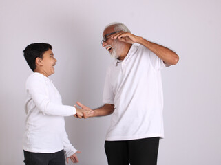 Happy Indian grandfather and grandson spending quality time