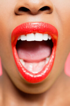 Cropped image of African American woman with red lips and mouth open.