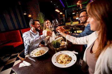 Young people having dinner in the restaurant