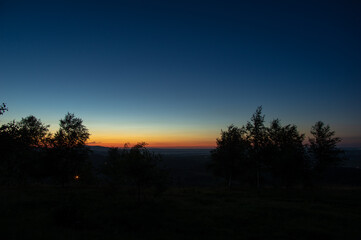 Fototapeta na wymiar Silhouettes of trees against the background of a beautiful sunrise