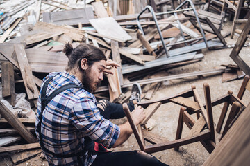 Carpenter man cutting wood with saw. craftsman working workshop factory industry.  Capenter worker with mask protection.