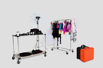 Clothes rack and photographic equipments with suitcases in studio