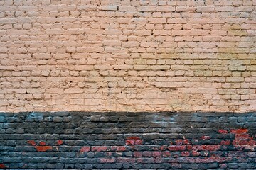 texture of painted old brick for background or wallpaper with two horizontal areas of different color surface