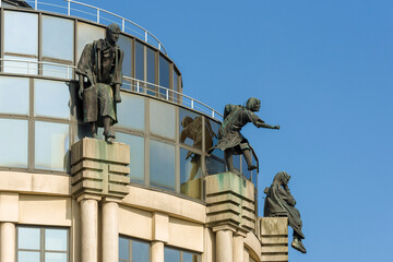 Fototapeta na wymiar Statues on roof of the shopping center at the Zuid South quarter in Ghent, Belgium