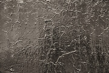 abstract rough painted glossy black surface for a textured background or wallpaper