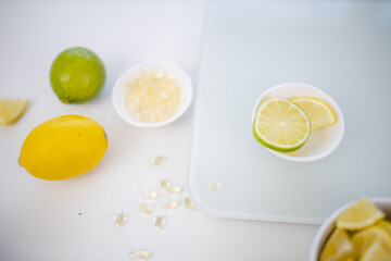 Bowl of vitamins and a bowl of lemon and lime slices