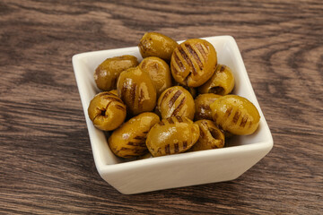 Green grilled olives in the bowl