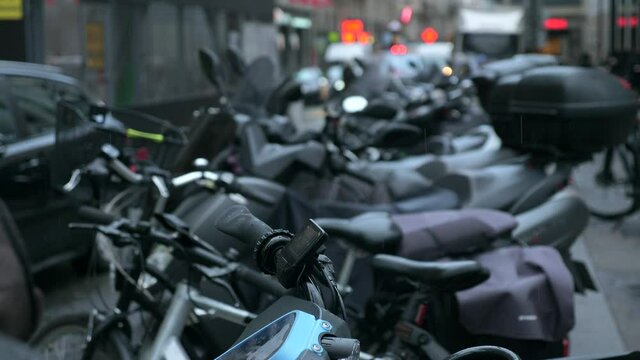 Raindrops Fall on Motorcycles Motor Bicycles Bikes. On Busy Street Parking Lot Area. Paris France Europe 2020. 2x Slow motion 60 FPS 4K
