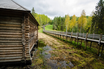 Wooden bridge on stilts through the wetlands. Open-air museum "Malye Korely". Russia, Arkhangelsk region