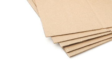 Corrugated cardboard isolated on white background. Five sheets of dark thick paper are stacked one on top of the other with a shift. Subject casts soft, small shadows.