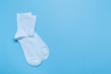 blue new socks stacked on a blue background. top view.