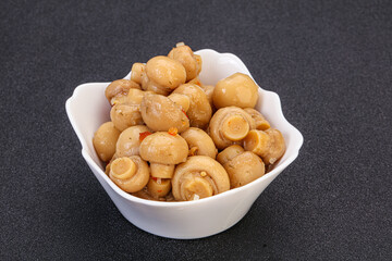 Pickled champignons in the bowl